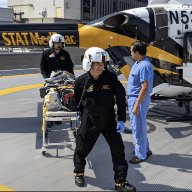 Flight crew transporting simulated patient.